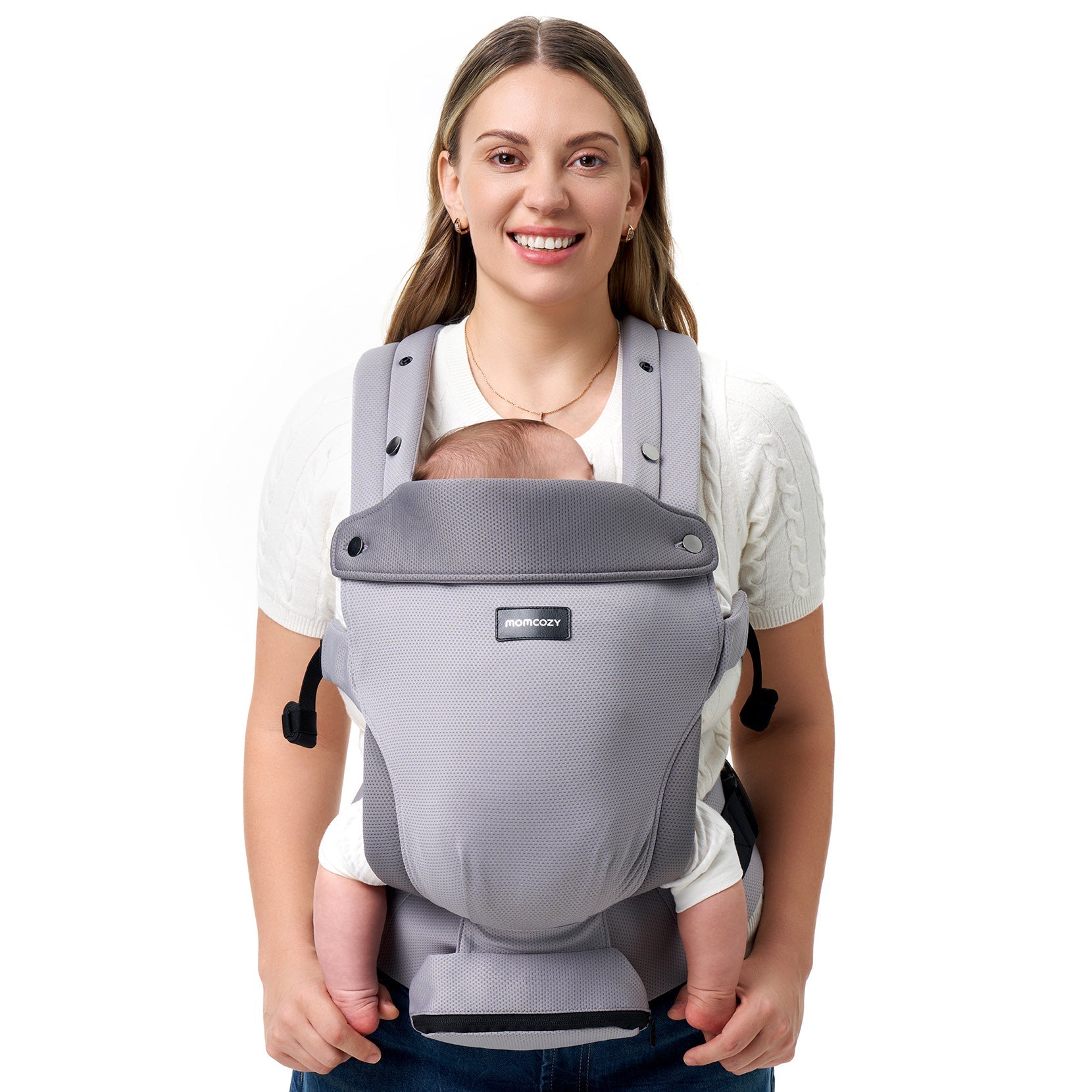 Momcozy baby carrier in gray, worn by a smiling parent with a sleeping baby, mesh design, ergonomic and comfortable.