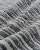 Momcozy baby carrier close-up, featuring luxurious linen fibers, striped texture, and natural elegance.