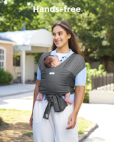 Gray Momcozy baby wrap carrier, hands-free design for comfort. Babywearing with breathable material. 'Hands-free' text.