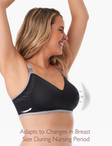 Woman wearing black nursing bra raising arms, showing adaptability for changing breast size.