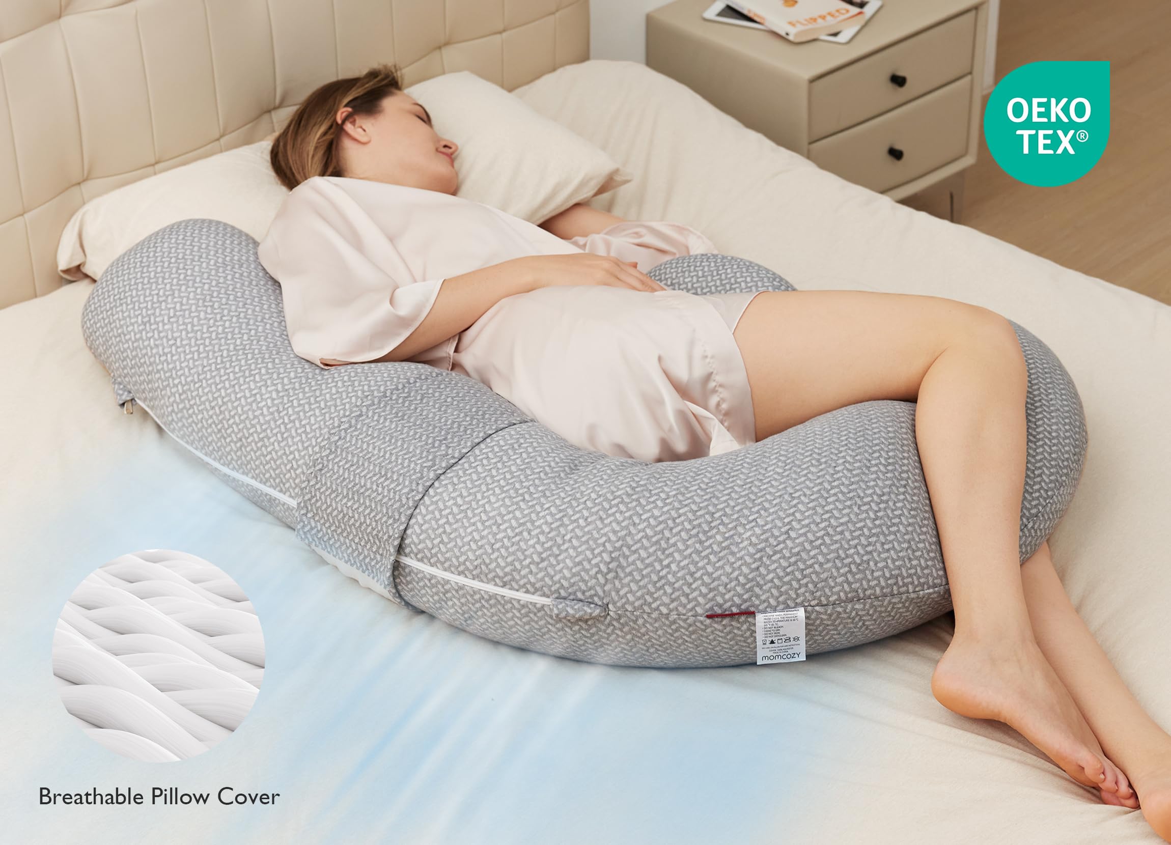 Gray Momcozy F-shaped pregnancy pillow. Provides support and comfort for pregnant women during sleep.