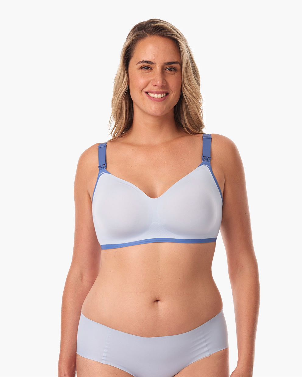 Smiling woman in blue fog nursing bra with adjustable straps, highlighting comfortable fit.