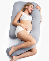 Momcozy Dreamlign pregnancy pillow, gray color, supporting pregnant woman's comfort and sleep.