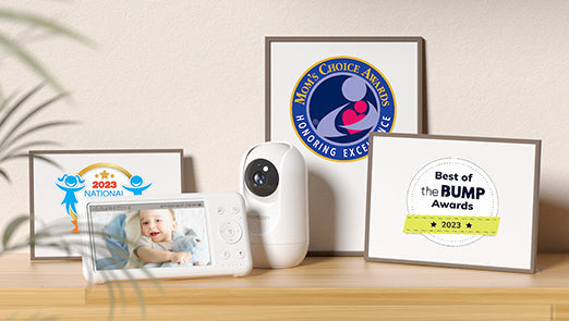 Momcozy BM01 baby monitor with awards: Mom's Choice, Best of the BUMP 2023, National 2023. Baby monitor screen.