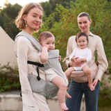 Momcozy Move2Fit Hip Seat Carrier in use. Mothers and babies comfortably wearing the carrier outdoors.